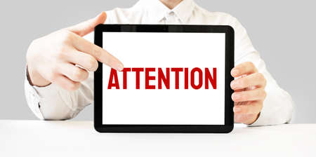 Text BACK TO BASICS on tablet display in businessman hands on the white bakcground. Business conceptの写真素材