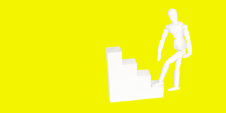 Figure of wooden man climb up the stairs of success or career. Concept of career up, success in...