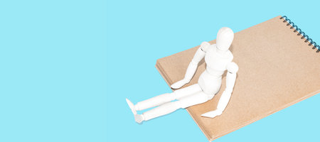 wooden mannequin isolated on blue background. Business conceptの写真素材