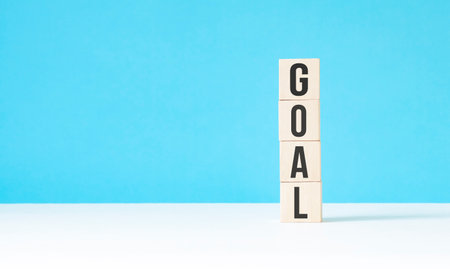 goal new year wooden cubes on blue table background with copy space for text. Business Goals,...
