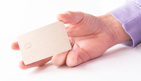 Male hand paying with the credit card isolated on white backgroundの写真素材