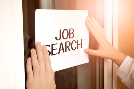 Closeup of owner holding text JOB SEARCH in storeの写真素材