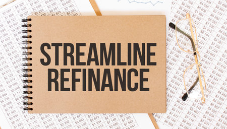 Craft color notepad with text STRAMLINE REFINANCE. Notepad with eyeglasses and text documents. Business conceptの写真素材