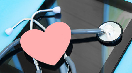Stethoscope with clipboard and digital tablet on doctor deskの写真素材