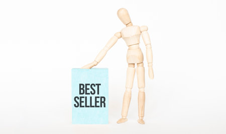 BEST SELLER concept. Wooden puppet touch green wooden block. Business conceptの写真素材