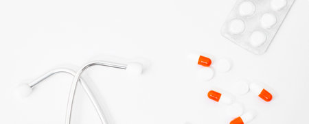 stethoscope, red heart sheet of paper for notes on a white background on the tableの写真素材