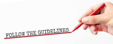 Hand writing FOLLOW THE GUIDELINES with marker, concept backgroundの写真素材