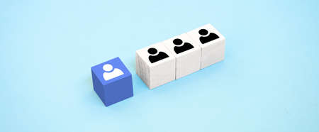 Concept of recruitment, hiring, promotion or team building in business. Wooden cubes with employee icons.の写真素材