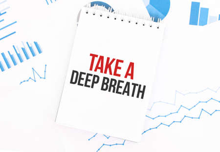 White notepad with text Take a deep breath on the financial documentation. Finance and business conceptの写真素材