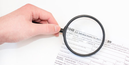 Closeup photograph of the 1040 federal government individual income tax return form in a white...