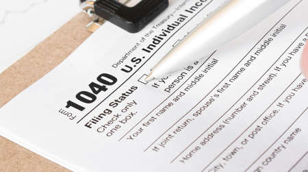 1040 Tax Form being filled out. Shallow depth of fieldの写真素材