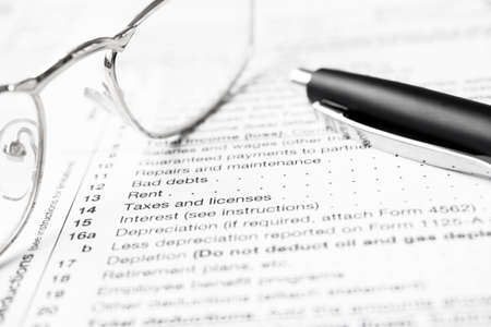 Federal income tax laws W9 form. Pen and spectaclesの写真素材