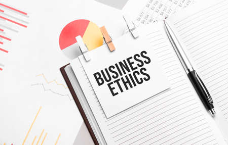 text BUSINESS ETHICS on stickers on the diary with office toolsの写真素材