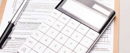 A Tax Form, Pen and Calculator. Finance concept