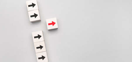 Leadership concept, Wooden block with red arrow icon on blue background.の写真素材