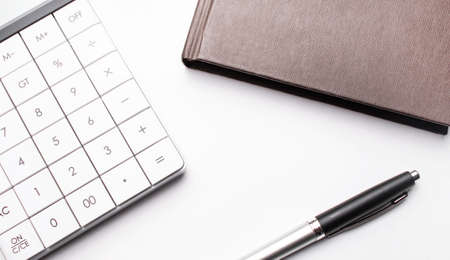 Top view of notebook, calculator and penの写真素材