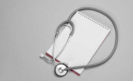 Stethoscope, notepad on a gray background. Healthcare and medical concept with copy space.Bannerの写真素材