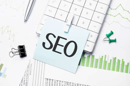 text SEO Written words on paper notebook. workplace. Business concept.