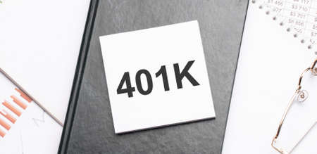 Notepad with text 401K Planning on a charts and numbers. Business concept.の写真素材