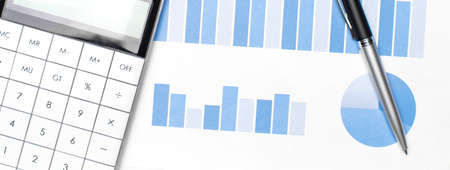 A calculator and pen on financial papersの写真素材