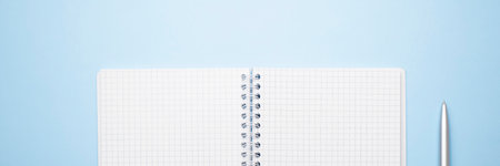 notebook with pen on blue background top view, flat layの写真素材
