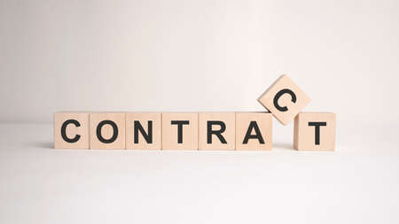 The word contract is written on wooden cubes on a light background. Business conceptの写真素材