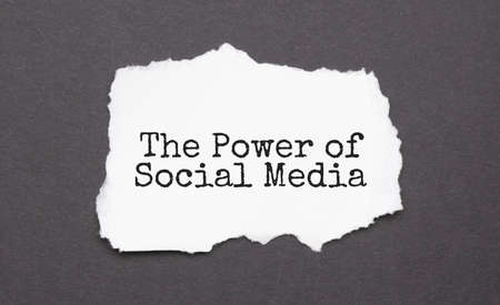 THE POWER OF SOCIAL MEDIA sign on the torn paper on the black backgroundの写真素材