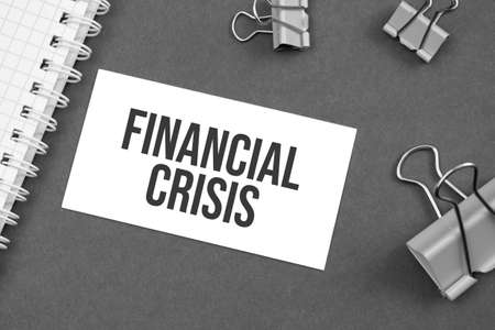 The word financial crisis word written on gray background with paper clips. wordの写真素材
