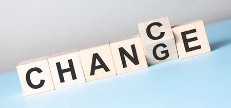 Wooden cube flip with word change to chance on blue table,の写真素材