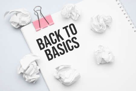 BACK TO BASICS. Blank sheet of paper, red paper clip, word Ideas and crumpled paper wadsの写真素材