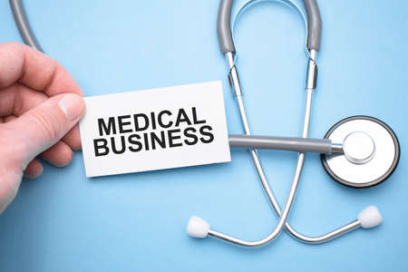 Doctor holdnd stethoscope and paper sheet woth text medical business. Medical conceptの写真素材