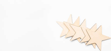 Wood block five star shape on wooden table gray background. Block 5 stars rated best service...