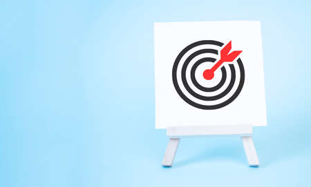 Easel with an arrow in the target center. Direct hit, Marketing and targeting audience.