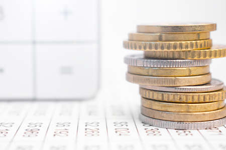stacks of coins with numbers on documentsの写真素材