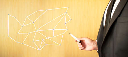 Businessman draw growth graph and progress of business and analyzing financial and investment data, business planning and strategy on blue background.の写真素材