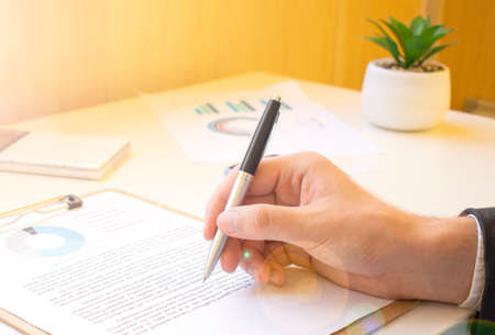 Hand of businessman working with graph and diagram, Businessman analyzing income charts and graphs,の写真素材