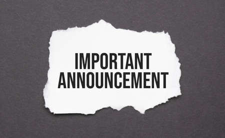 Important Announcement sign on the torn paper on the black backgroundの写真素材