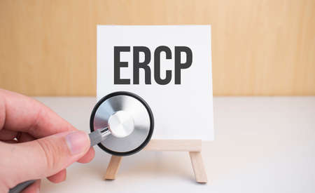 Doctor holds stethoscope and easel with text ercpの写真素材