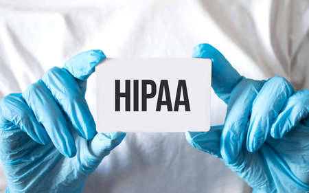 Doctor holding a card with text hipaa, medical conceptの写真素材
