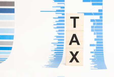 tax inscription, tax burden concept, wooden cubes.