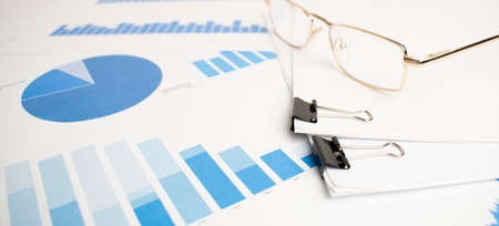 The glasses were placed on the data report documents, graphs and charts for preparation of the...