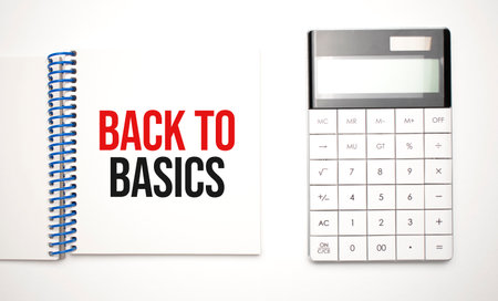 calculator and notepad with text back to basicsの写真素材