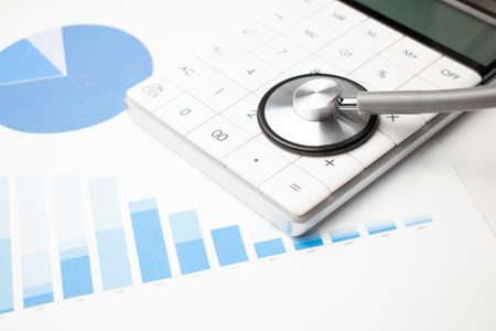 stethoscope, calculator and documents. Medical and insurance concept