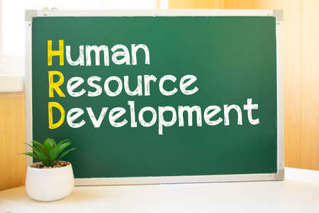 hrd in chalk on the school board, Search engine optimization and websites. Desk, swept balls of paper, computer keyboardの写真素材
