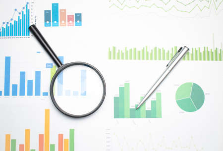 Single Magnifying Glass with Black Handle, Leaning on the financial data. Concept of Business and Finance research .の写真素材