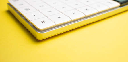 Modern calculator, Business and Finance accounting concept on yellow background with space for text.の写真素材