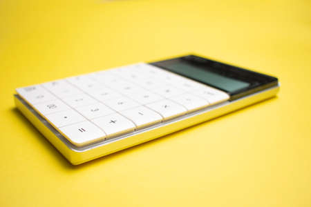 Modern calculator, Business and Finance accounting concept on yellow background with space for text.の写真素材