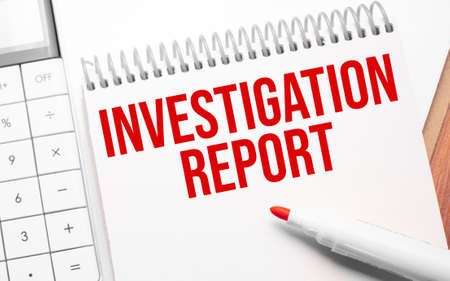 Notepad with text Investigation Report on wooden background with calculator and red markerの写真素材