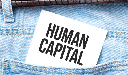 Human Capital words on a white paper stuck out from jeans pocket. Business concept.の写真素材