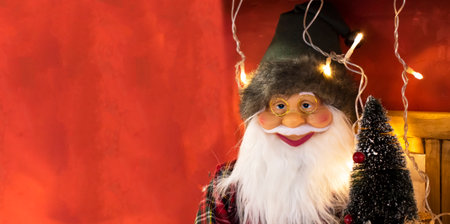 Santa Claus figurine on the red background. 2022 christmas concept